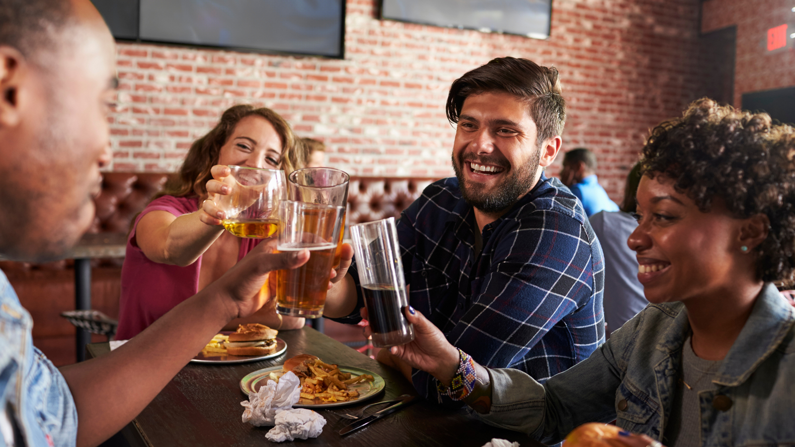 A group of people enjoying social life at a restaurant.