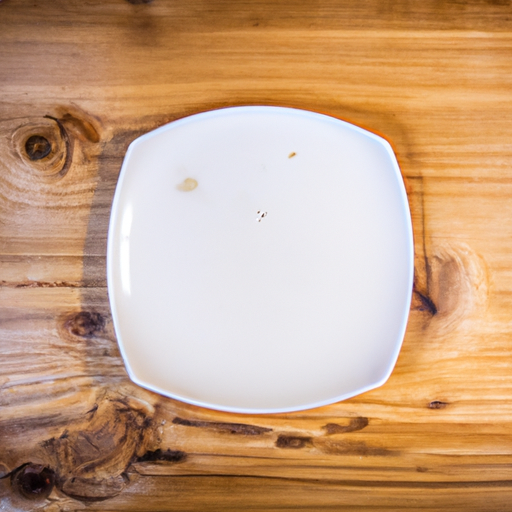 A white plate on a wooden table.