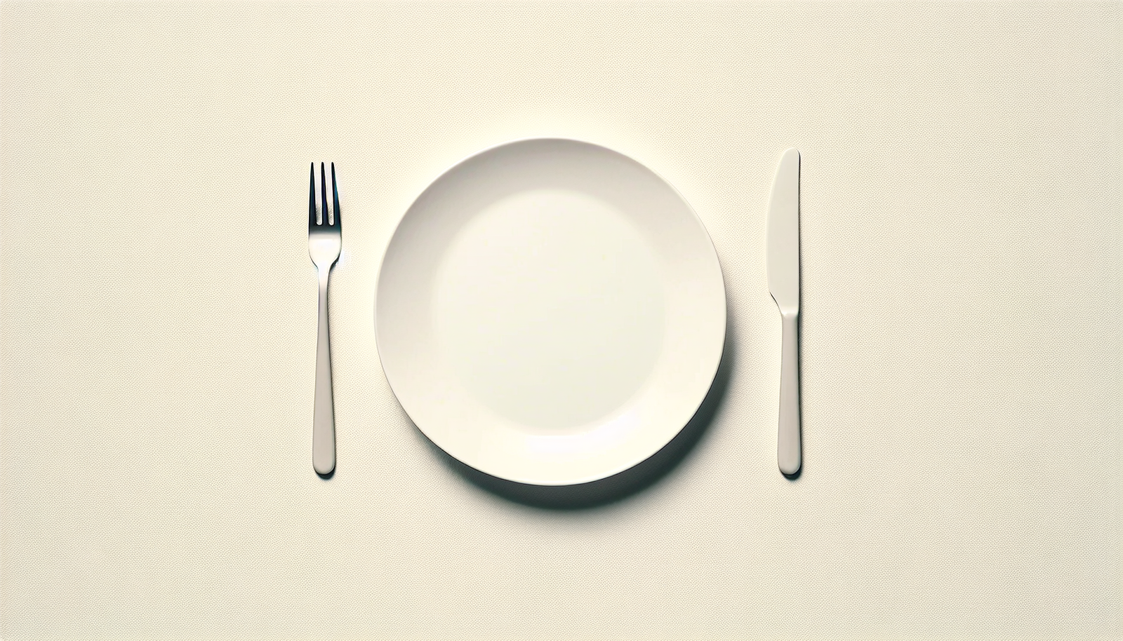 A white plate with a knife and fork on it.